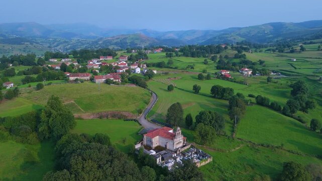 Aerial drone view of the Church of Santa Mar&iacute;a in Tezanos and the surrounding countryside in summer near the village of Villacarriedo in the Pasiegos Valleys. Cantabria. Spain. Europe