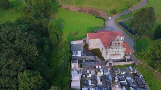 Aerial drone view of the Church of Santa Mar&iacute;a in Tezanos and the surrounding countryside in summer near the village of Villacarriedo in the Pasiegos Valleys. Cantabria. Spain. Europe