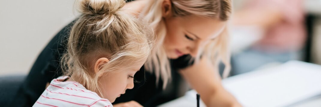 Teacher helping young student with school work, patient guidance during primary education classroom learning