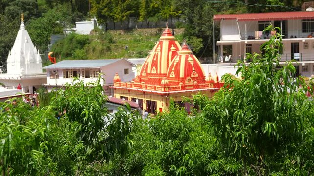 Colorful Hindu Temple Amid Greenery at Kainchi Dham, Uttarakhand