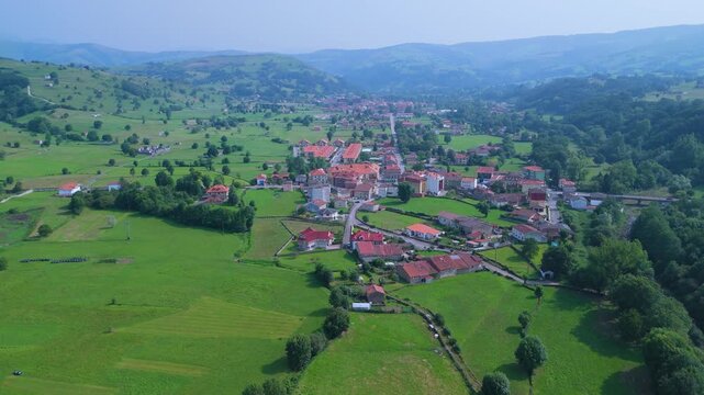 Aerial drone view of the summer countryside surrounding the village of Villacarriedo in the Pasiegos Valleys, Cantabria, Spain, Europe
