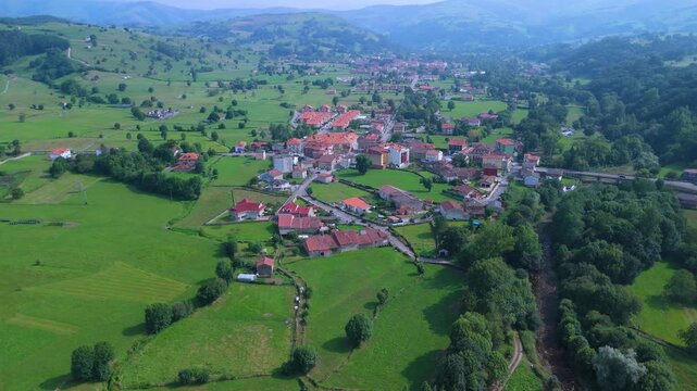 Aerial drone view of the summer countryside surrounding the village of Villacarriedo in the Pasiegos Valleys, Cantabria, Spain, Europe