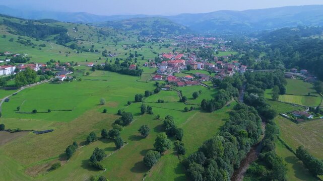 Aerial drone view of the summer countryside surrounding the village of Villacarriedo in the Pasiegos Valleys, Cantabria, Spain, Europe