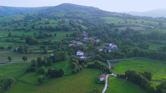Aerial drone view of the summer countryside surrounding the village of Villacarriedo in the Pasiegos Valleys, Cantabria, Spain, Europe