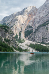 Vertical view of wooden rowing boats on emerald water at Lago di Braies Dolomites © WeiChun