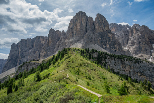 Hiking footpath leading towards dramatic Gran Cir and Sella peaks at Passo Gardena