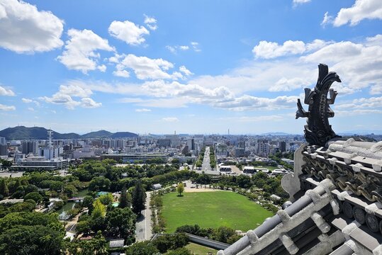 Panoramic View of Himeji City Sky and Shachihoko Roof Tile Fish Ornament from Himeji Castle Tower in Hyogo, Japan.