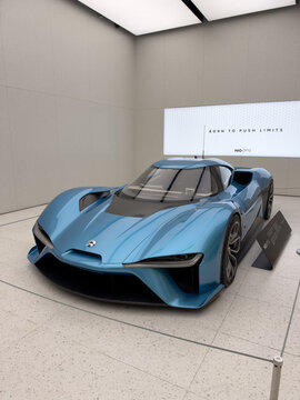 Shenzhen, China - September 21, 2026: Vertical NIO EP9 blue electric hypercar front with slogan wall