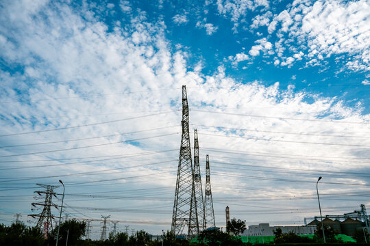 High Voltage Power Transmission Towers Under Blue Sky