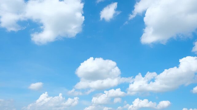 A blue sky cloud timelapse video captures fluffy cumulus and scattered stratocumulus clouds drifting with winds under bright sunlight, revealing pleasant daytime weather and atmospheric movement. 4k.