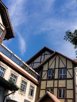Historic half-timbered buildings with steep roofs against clear blue sky