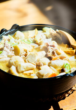 Japanese imoni hot pot with taro pork and vegetables in cast iron pot with natural light