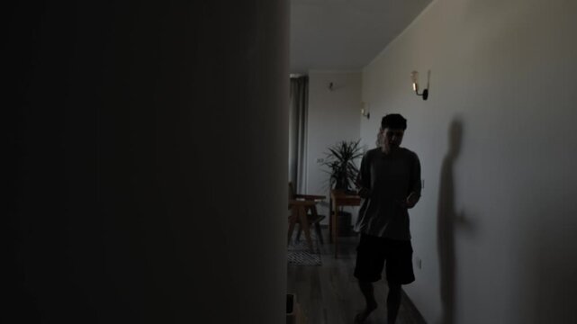Man pacing alone at home in regret after relationship breakup