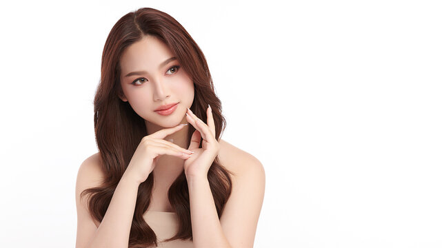 A beautiful young Asian woman with clean, fresh skin against a white background. Skincare, facial treatment, cosmetology, beauty, and spa. An elegant portrait of an Asian woman.