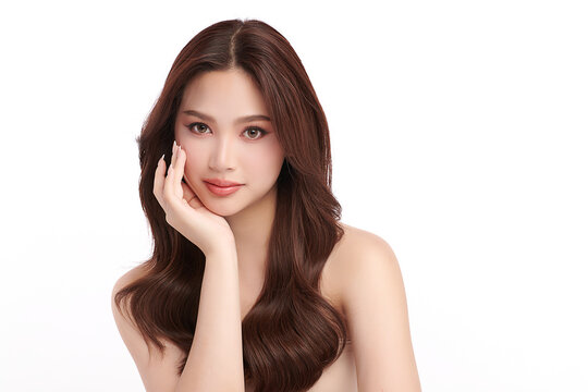 A beautiful young Asian woman with clean, fresh skin against a white background. Skincare, facial treatment, cosmetology, beauty, and spa. An elegant portrait of an Asian woman.