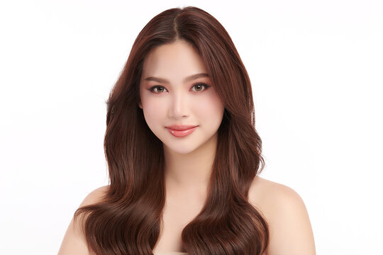 A beautiful young Asian woman with clean, fresh skin against a white background. Skincare, facial treatment, cosmetology, beauty, and spa. An elegant portrait of an Asian woman.