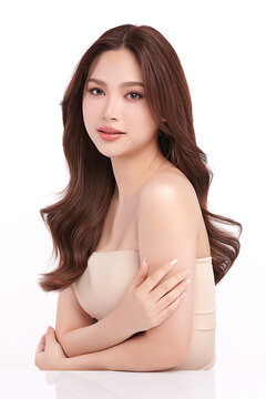 A beautiful young Asian woman with clean, fresh skin against a white background. Skincare, facial treatment, cosmetology, beauty, and spa. An elegant portrait of an Asian woman.