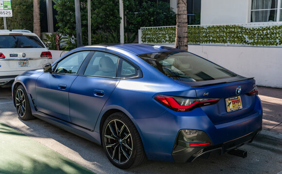 Miami, Florida, USA - December 06, 2025: BMW i4 electric liftback sedan coupe style car. Electric car BMW i4. Car BMW i4 parked outdoor. Blue electric car, corner view
