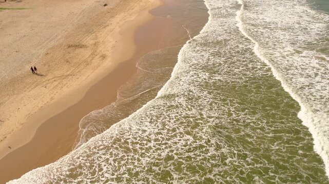 Aerial view of vagator beach in goa india with waves crashing on
