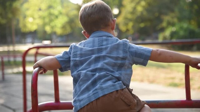 Playground fun play little boy. Kid climb and jump in the park. Sunshine summer nature. Family, children, people, active sport lifestyle. Bokeh background, closeup happy baby boy.