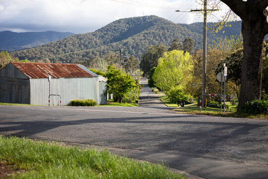 Scenic Rural Road Leading Toward Lush Green Hills