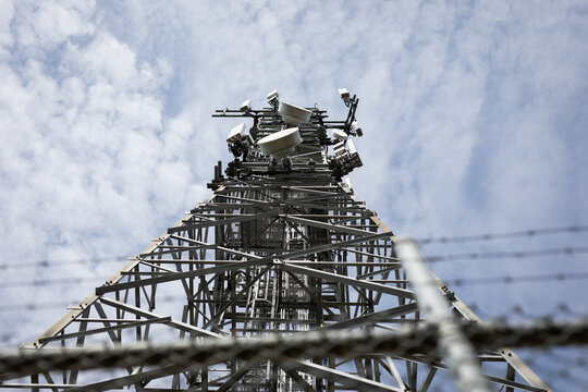 Telecommunications Tower Against Blue Cloudy Sky
