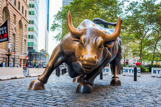 Charging Bull sculpture symbolizing financial power and resilience in Manhattan&rsquo;s Wall Street district, New York City, USA.