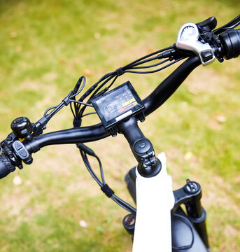 Close-up of the e-bike handlebar control system.
