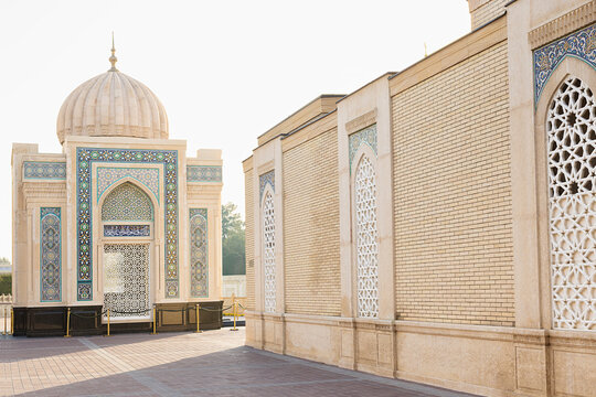 Hazrat Khizr mosque courtyard in Samarkand featuring ornate tilework and geometric lattice windows. Ideal for travel brochures, cultural publications, and architectural references about Uzbekistan.