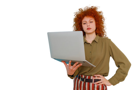 Redhead woman holding laptop, working remotely, focusing on screen, representing technology and professional tasks