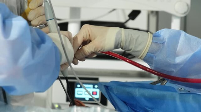 Surgeon team conduct rhinoplasty to patient with special tools in hospital closeup. Doctor changes shape of nose at aesthetic surgery