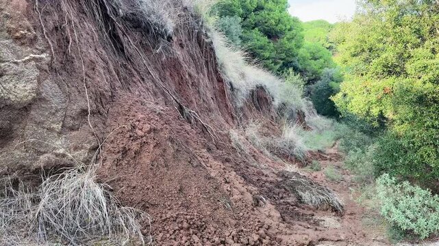 Video of soil erosion and mudslide on hillside covering a Mediterranean forest trail