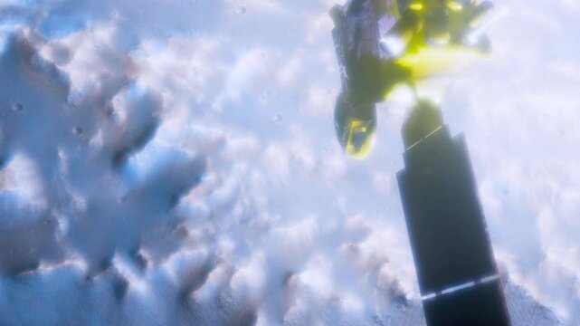 A sleek spacecraft hovers over dynamic, swirling clouds in a vibrant atmosphere. Sunlight glints off its metallic surface, illuminating the unusual landscape beneath.