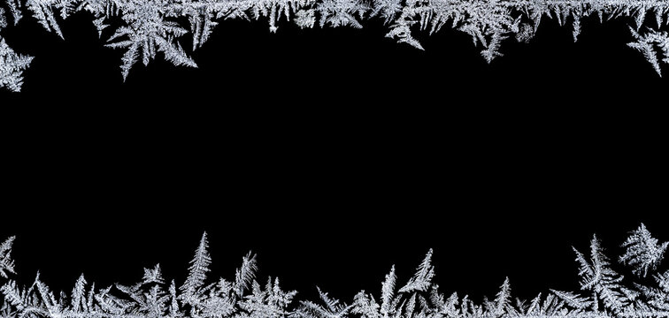 Frosty frame overlay. Rectangular frame of frost crystals on a black background with copy space. Perfect for winter cards, invitations, posters, photos and seasonal designs.