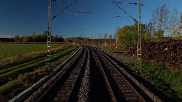 Railway tracks stretch ahead from the drivers cabin of a moving train showing continuous forward motion and the transportation route during the journey