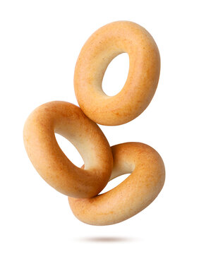 Three dry bagels flying on a white. Isolated