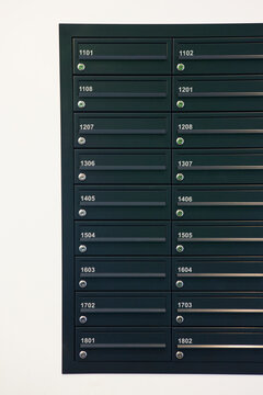 Close Up Of Numbered Mailboxes In Apartment Building