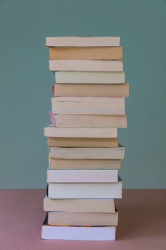 Pile of balancing paperbook books, a reading list.