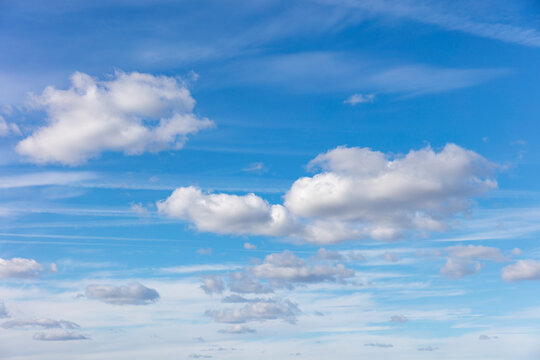 Cumulous clouds and sky, fluffy cloud shapes and blue sky background.