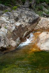 Crystal clear mountain stream water flowing over granite rocks and mini waterfall into green natural pool in Seoraksan National Park, scenic nature landscape wallpaper and summer travel background. © 상현 강