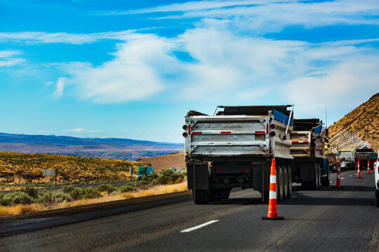 Highway construction along Interstate 90 from Vantage to George, vehicles with road mending materials.
