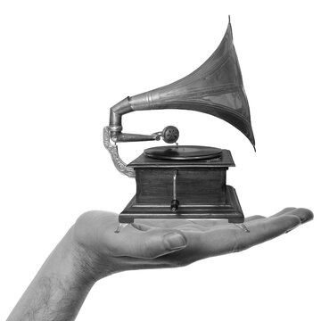 A hand displays a vintage gramophone. The gramophone has a large horn and is resting on a small wooden base. The scene is simple with a focus on the object against a transparent background.