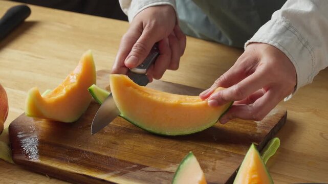 Removing Cantaloupe Rind from a Melon Wedge with a Kitchen Knife