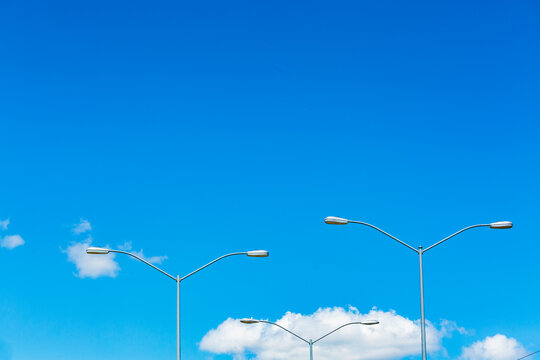 Lights on tall posts above a parking lot, street lighting.