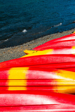 Row of red kayaks on shore at Lake Crescent, Olympic National Park, Port Angeles