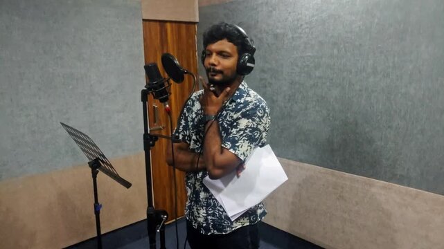 voice actor preparing to dub for film at dubbing studio at hyderabad, telangana, india. internal shot, static shot, 4k.