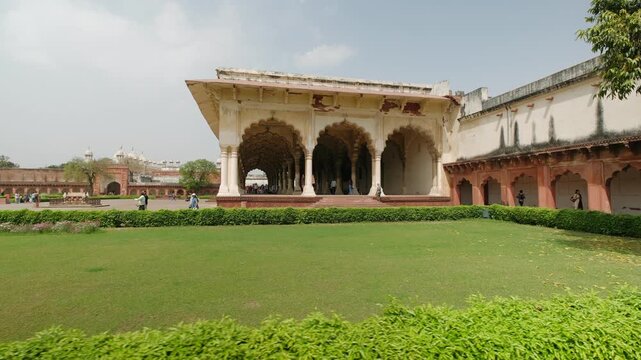 Tourists visiting the historic mughal architecture of diwan i aam public hall at agra fort in uttar pradesh, india