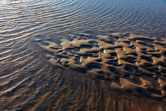 Tidepools and sand formations at low tide, Long Beach Peninsula, Washington, USA