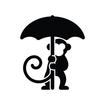 Cute monkey standing and holding a big black umbrella sign.