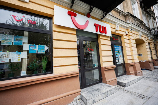 Travel agency storefront of TUI on a historic street in Radom, Poland showing tourism posters and glass entrance